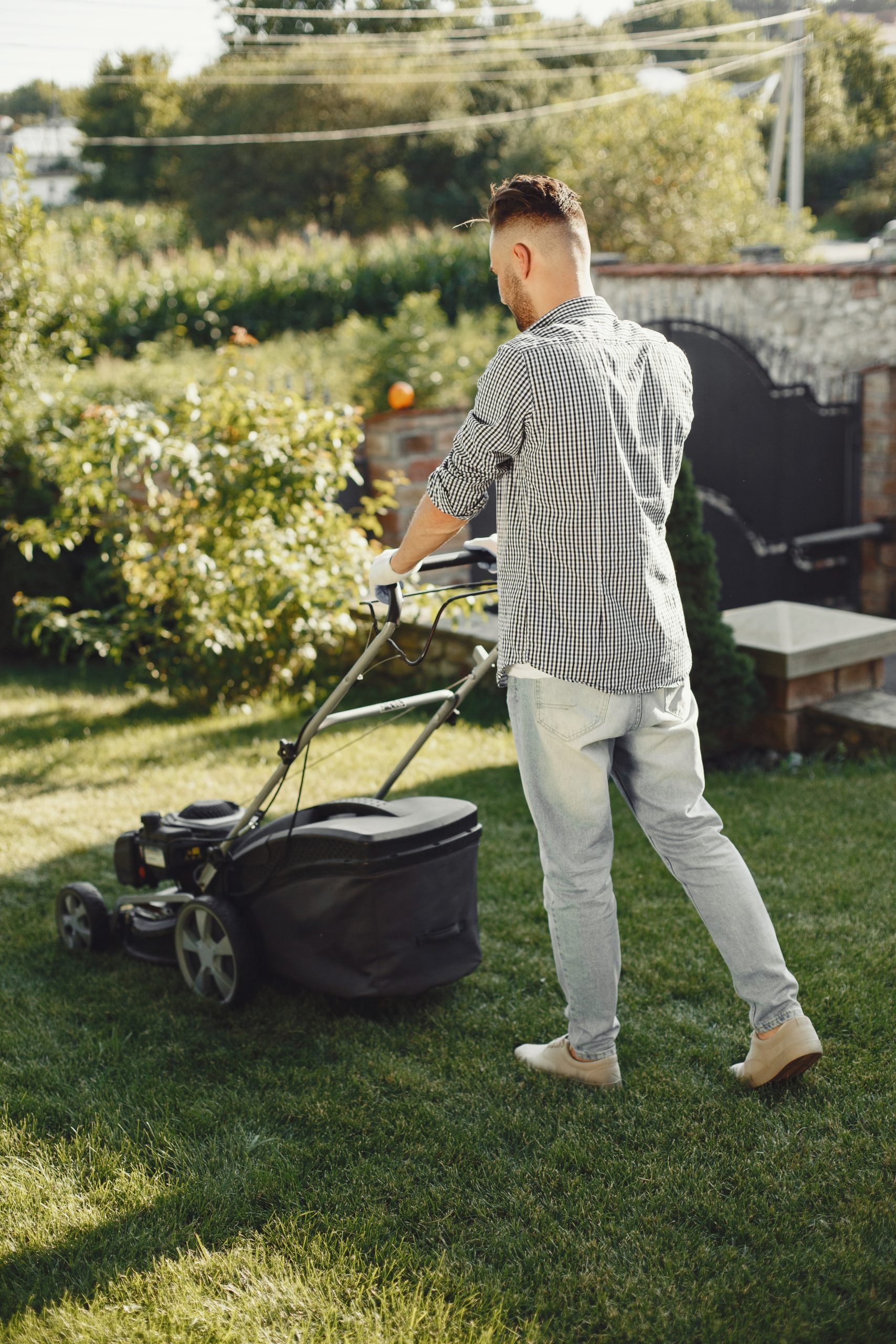 man cutting grass with lawn mover back yard male shirt scaled